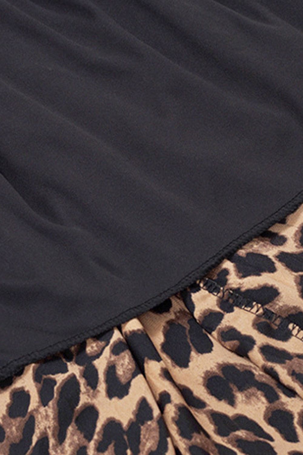 Close-up of Trendsi animal print plus size skirt with black fabric overlay detailing