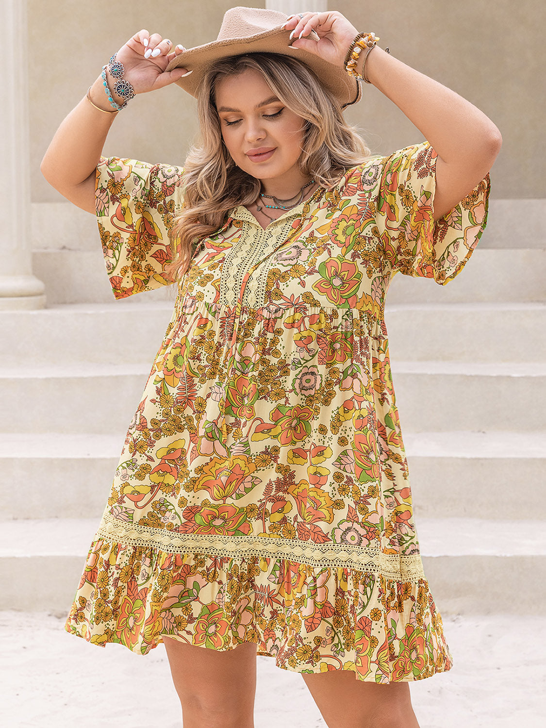 Trendsi plus size printed mini dress with floral pattern and ruffled hem worn with a beige hat