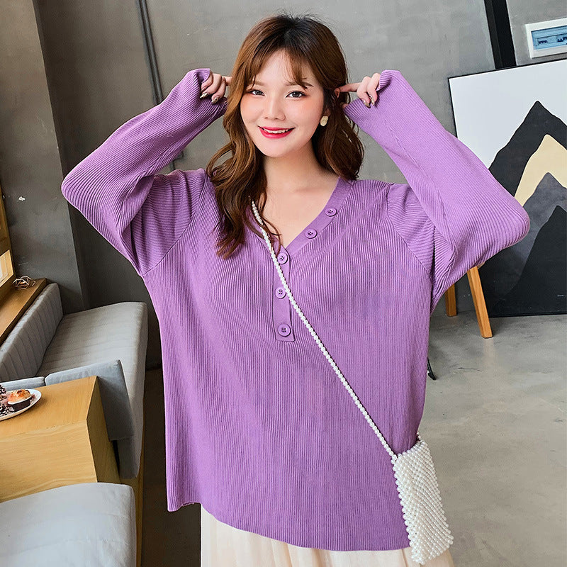 Purple button v-neck knit sweater for curvy women modeled indoors with white crossbody bag