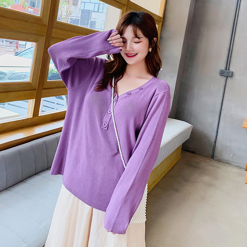 Purple button v-neck knit sweater for curvy women worn by a smiling woman in casual setting