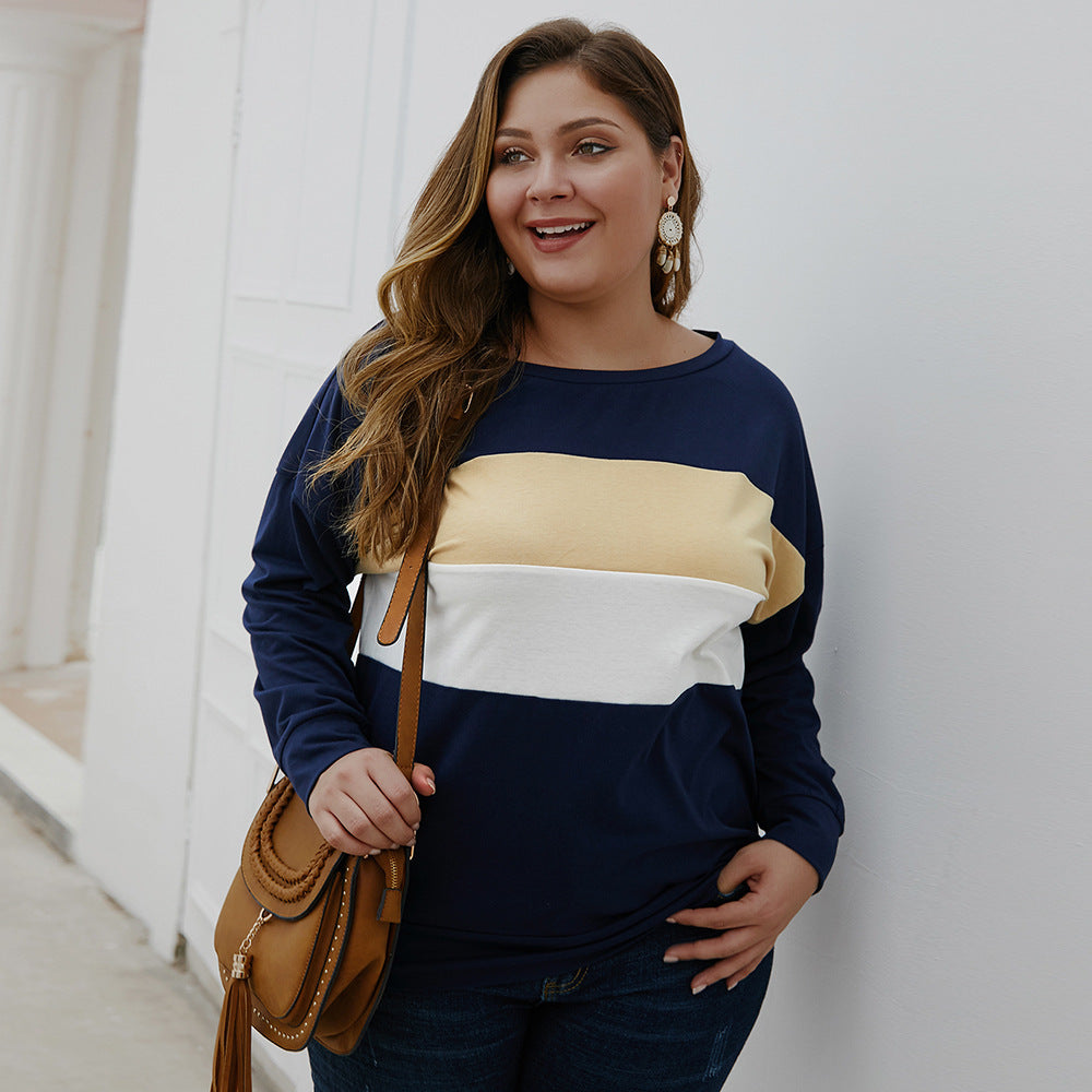 Plus size woman wearing navy blue casual plus size tops for women with beige and white stripes