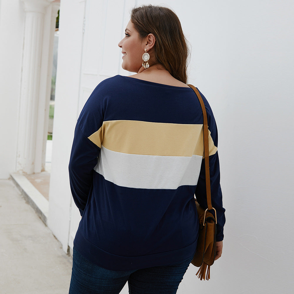 Plus size woman wearing navy color block casual plus size tops for women with long sleeves and shoulder bag