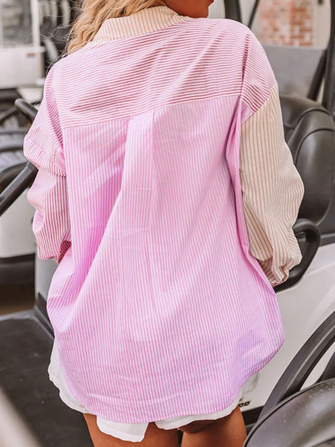 Back view of collared neck plus size blouse with mixed pink and beige stripes on model