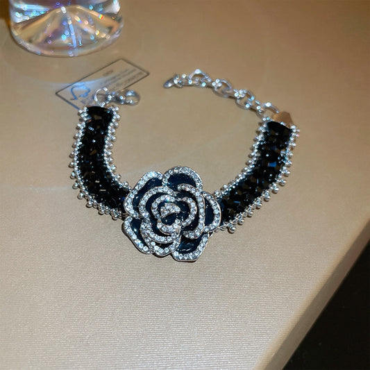 copper rhinestone flower bracelet with black stones and silver flower centerpiece