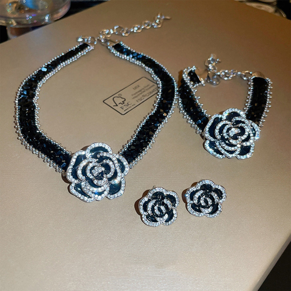 Trendsi copper rhinestone flower bracelet set with matching necklace and earrings in black and silver