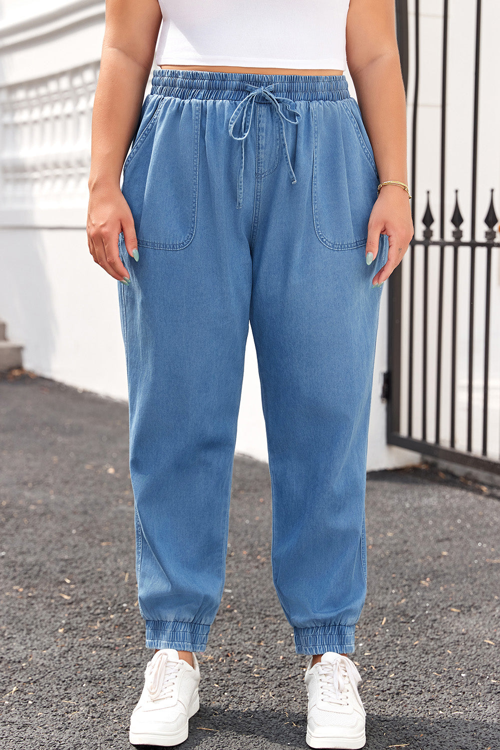 Plus size bottoms featuring drawstring waist plus size jeans in light blue denim with elastic cuffs