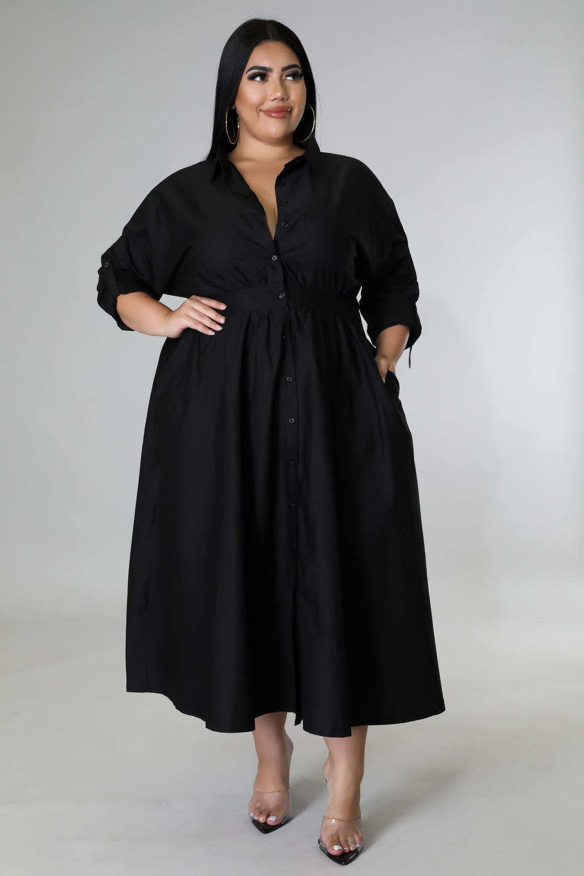 Plus size woman wearing a black button-down midi dress showcasing fashionable plus size dresses for women