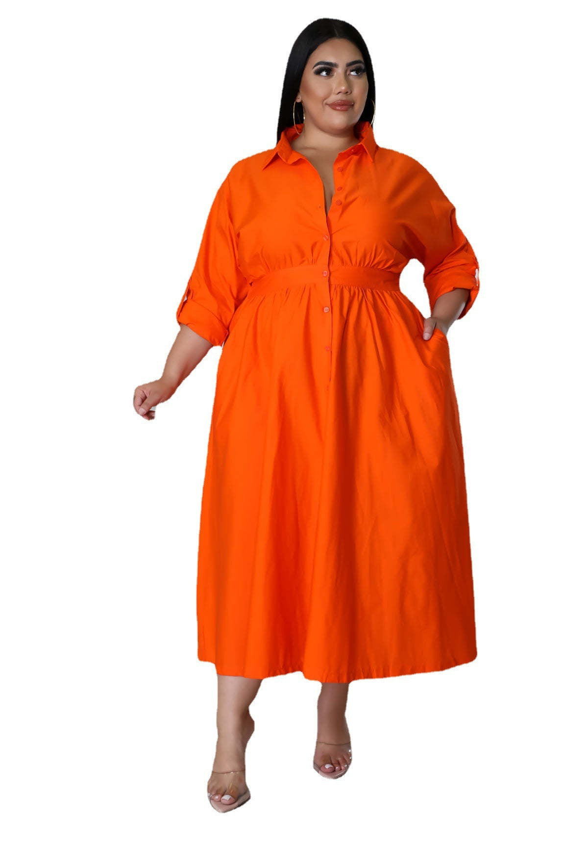 Plus size woman wearing a bright orange fashionable plus size dresses for women with long sleeves and a collar