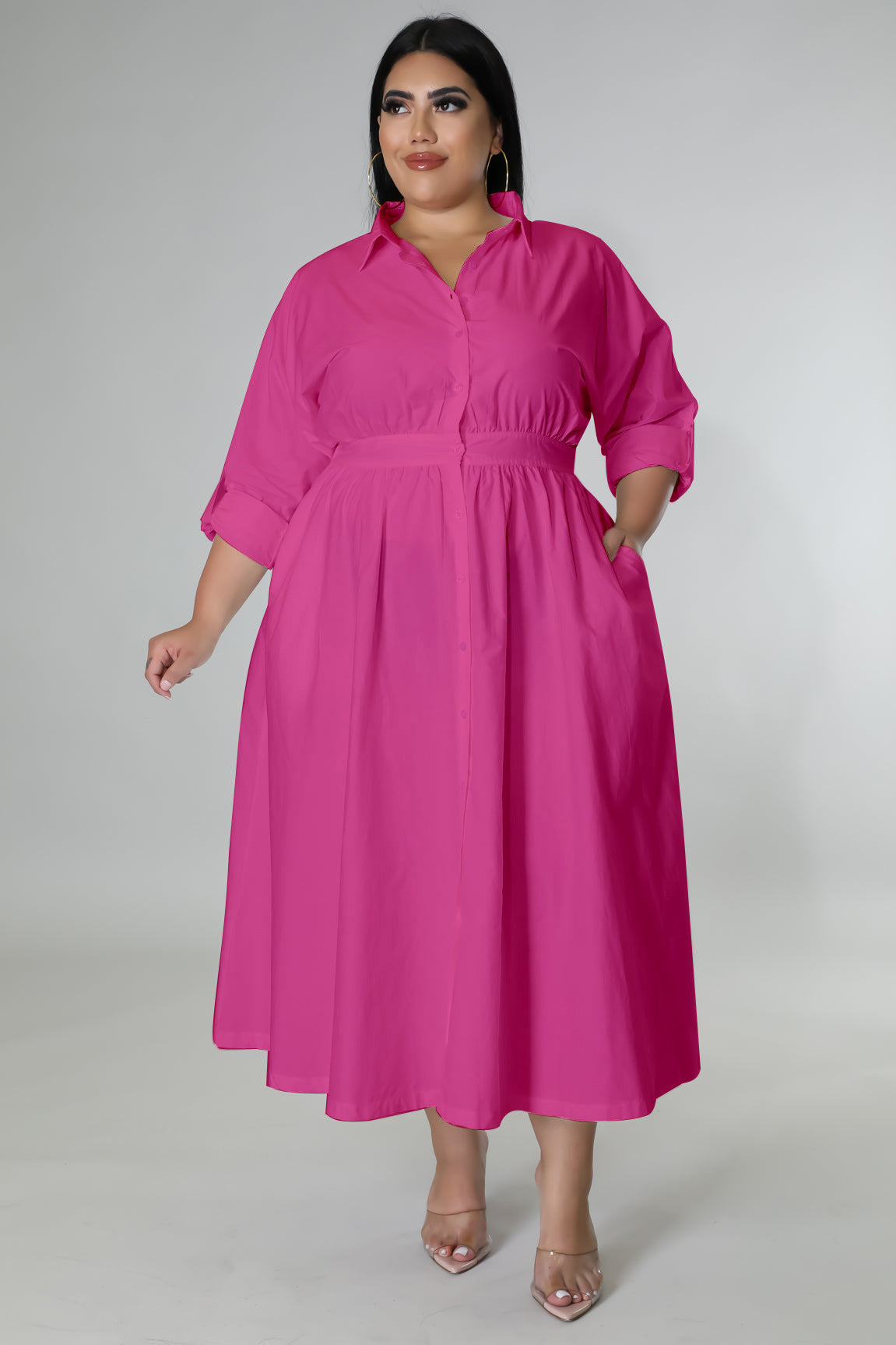 Plus size woman wearing a bright pink fashionable plus size dresses for women with pockets and quarter sleeves