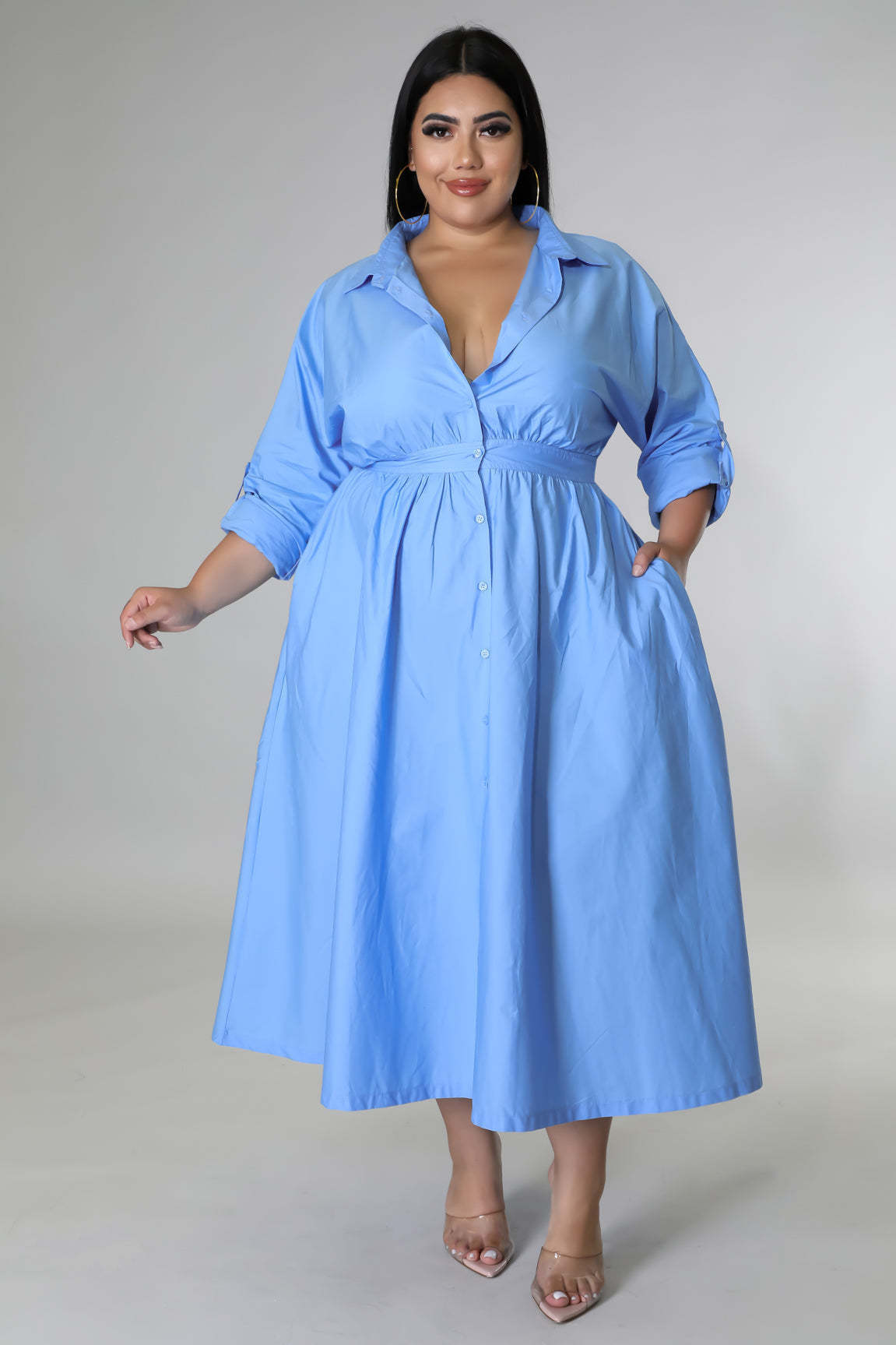 Plus size woman wearing a blue button-up midi dress showcasing fashionable plus size dresses for women