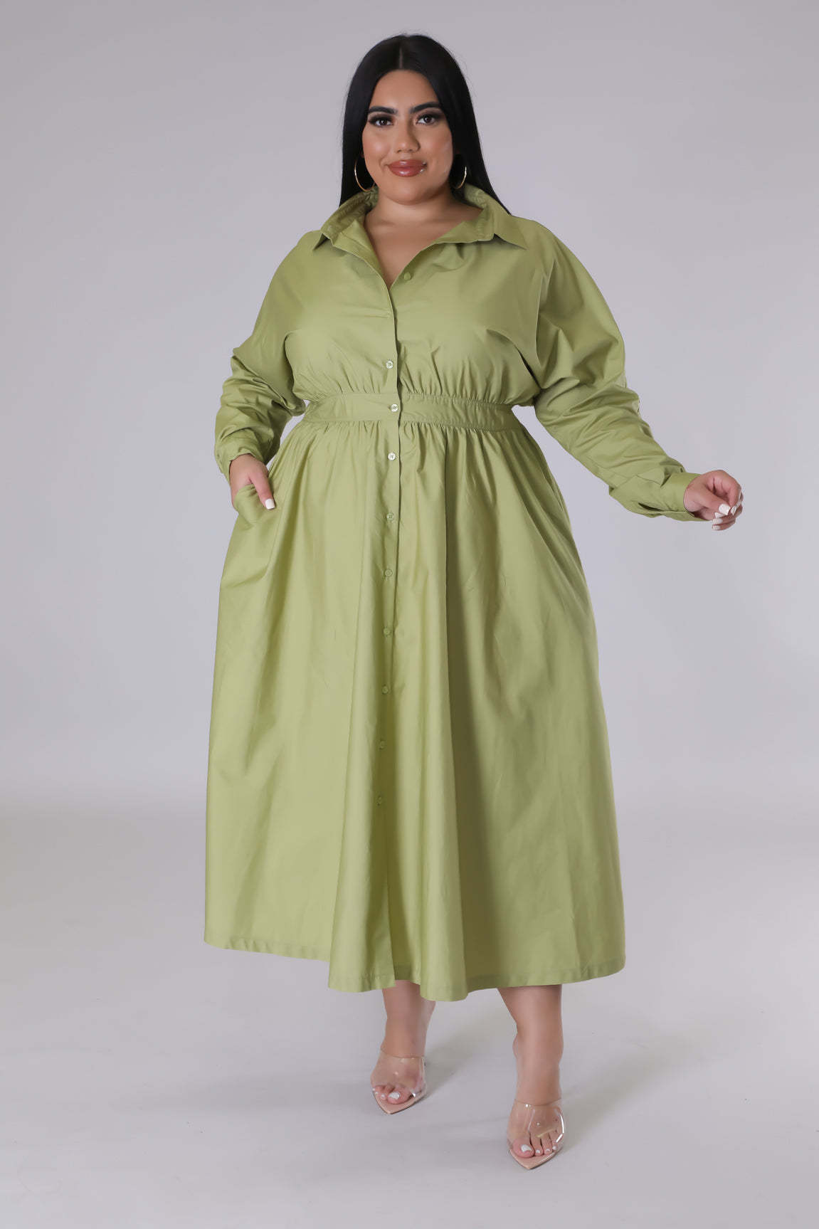 Model wearing a stylish green button-up long sleeve shirt dress showcasing fashionable plus size dresses for women
