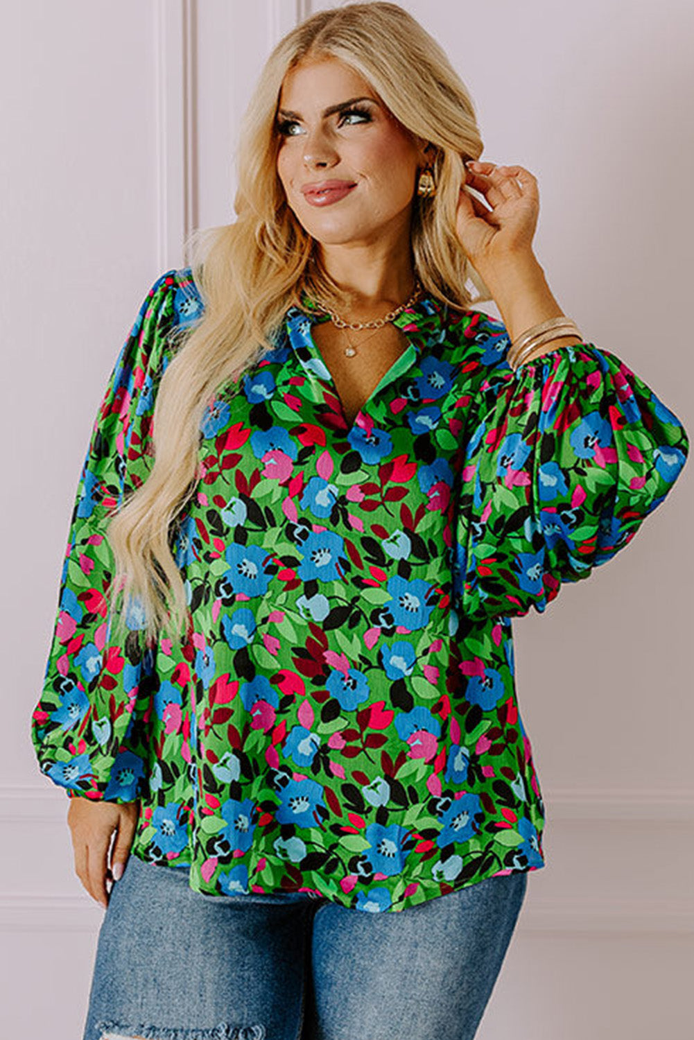 Floral print plus size blouse with vibrant blue green and pink flowers and puffed sleeves