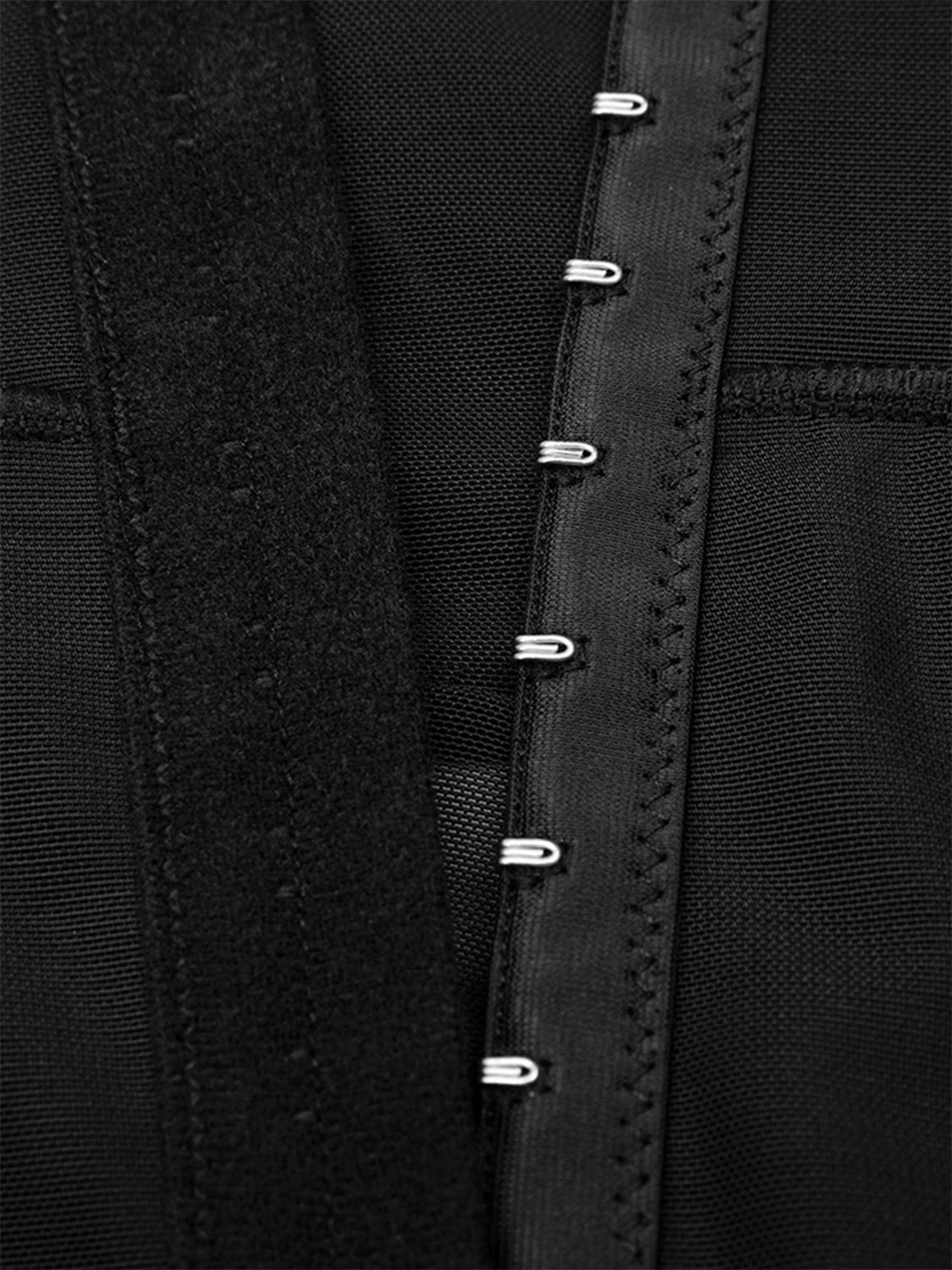 Close-up of black full size shaping bodysuit for women with hook and eye closure detailing
