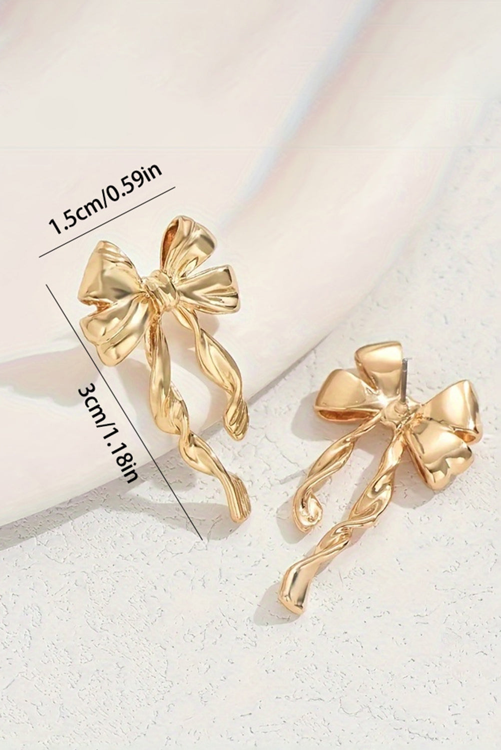 Gold bow stud earrings with twisted design measuring 3cm by 1.5cm by kjplussizefashion