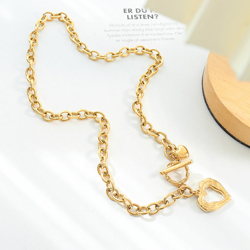 Trendsi gold titanium steel heart necklace with chain links and toggle clasp on white surface