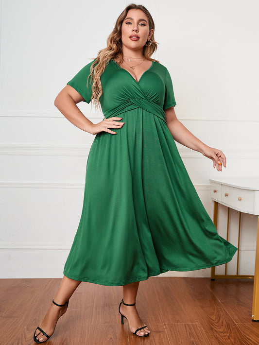 Trendsi green plus size short sleeve dress with v-neck and flowy midi skirt styled with black heels