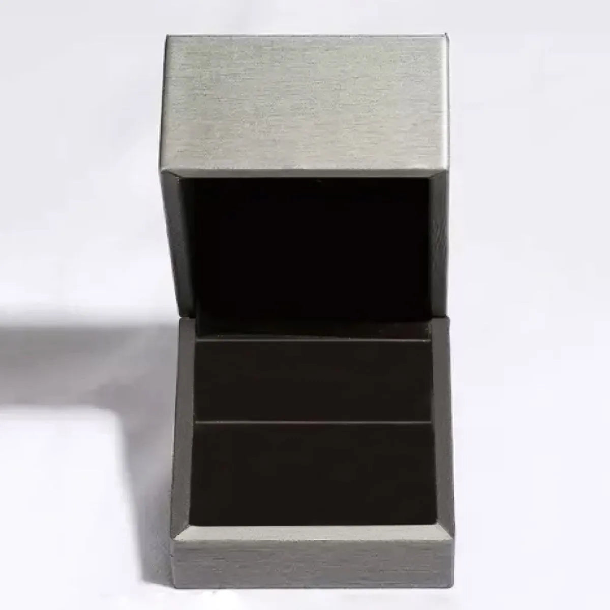 Empty gray ring box open to display a moissanite sterling silver ring from Trendsi