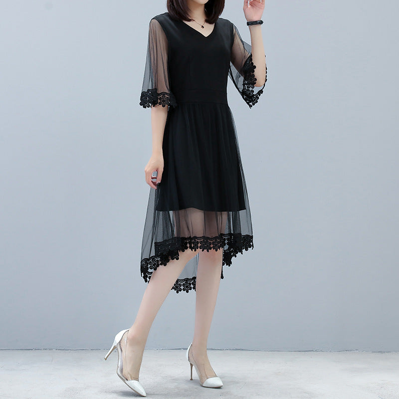 Elegant plus size black mid-length dress with sheer lace sleeves and hem, worn with white heels