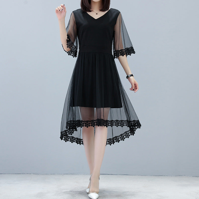 Elegant plus size black mid-length dress with sheer lace sleeves and hem on model
