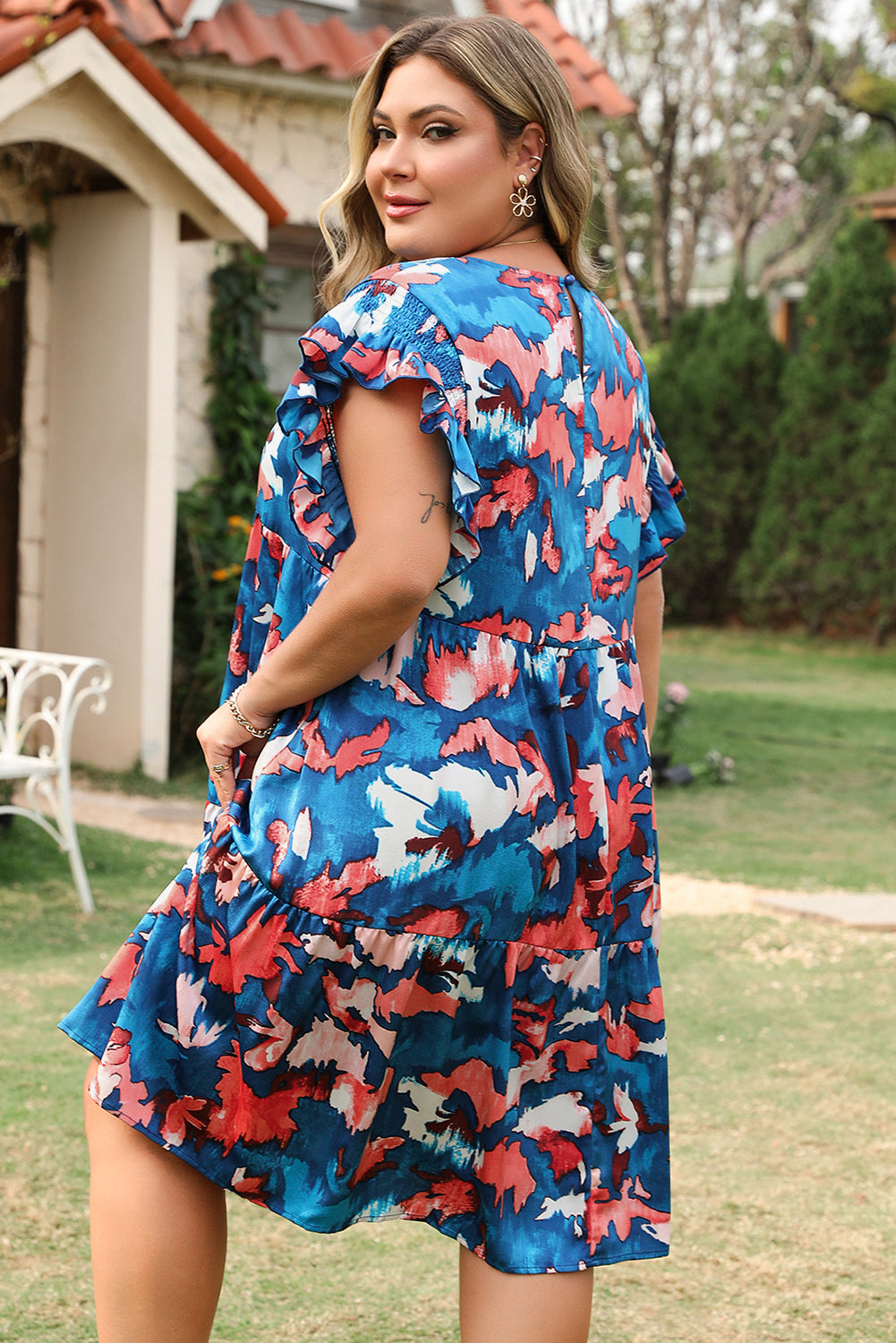 Plus size blue abstract mini dress with ruffle sleeves by kjplussizefashion worn outdoors
