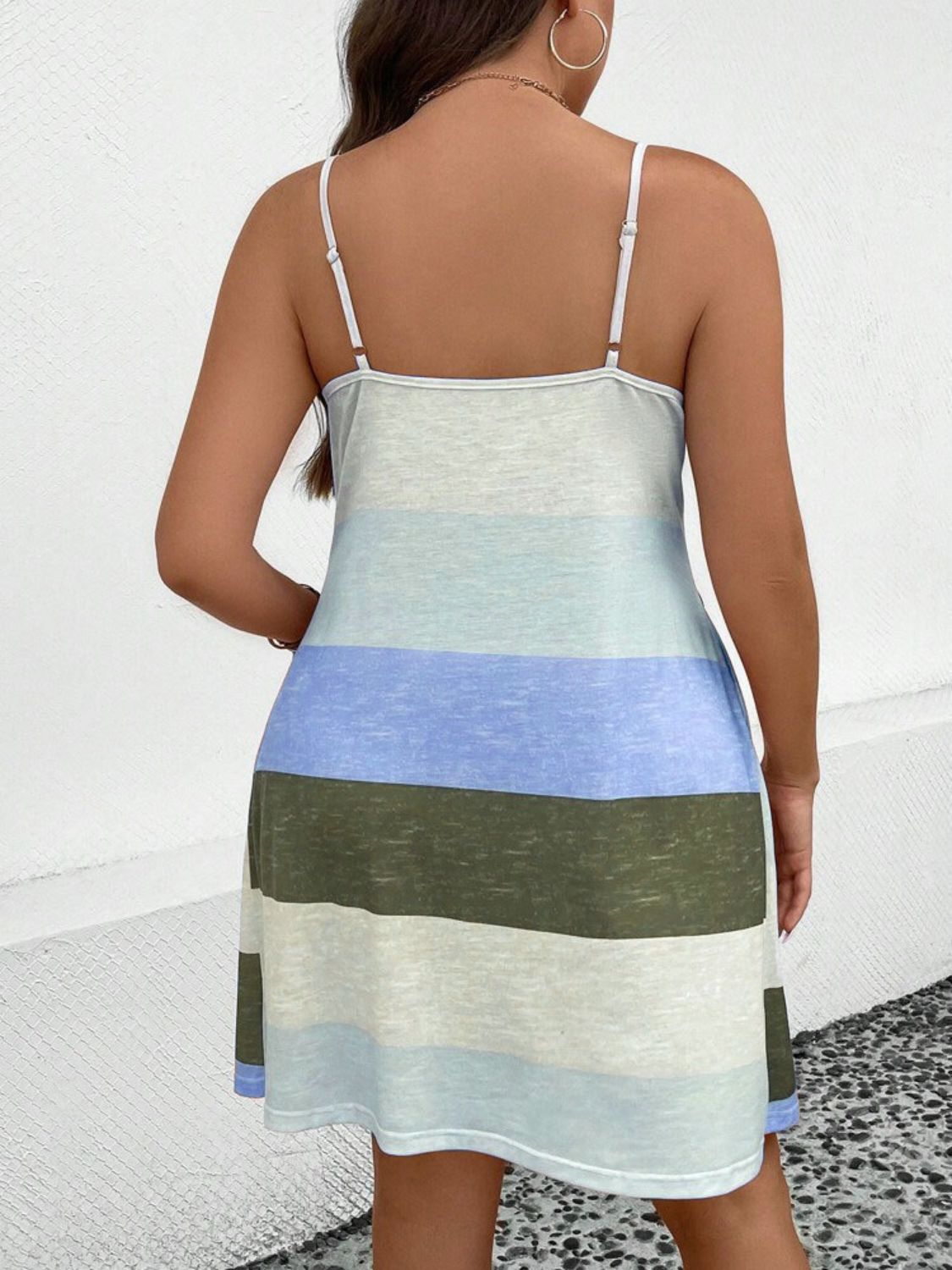 Back view of plus size color block mini dress with thin straps in blue, green, and white shades