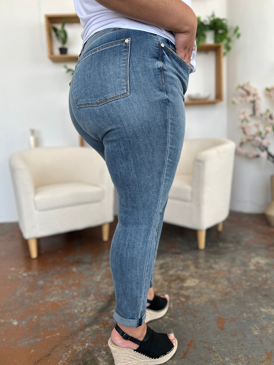 Trendsi plus size cuffed hem jeans in medium wash modeled with wedge sandals and white top