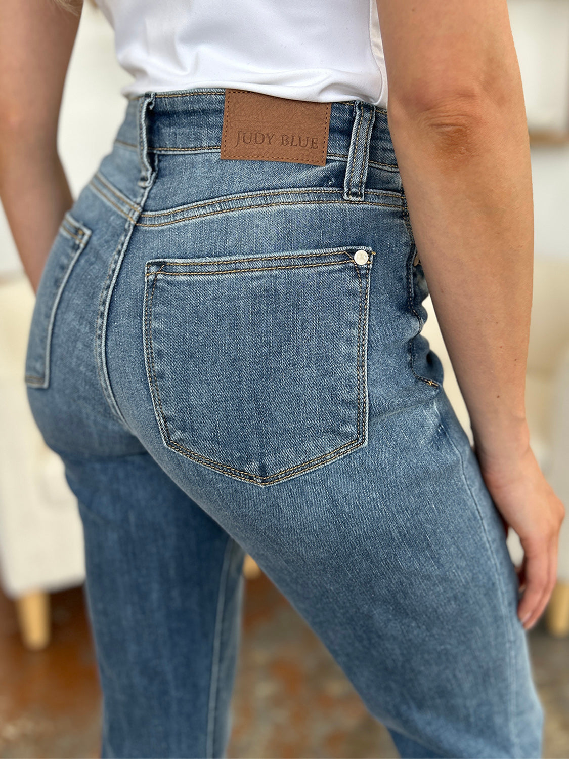 Back view of plus size cuffed hem jeans in blue denim from Trendsi worn with a white top