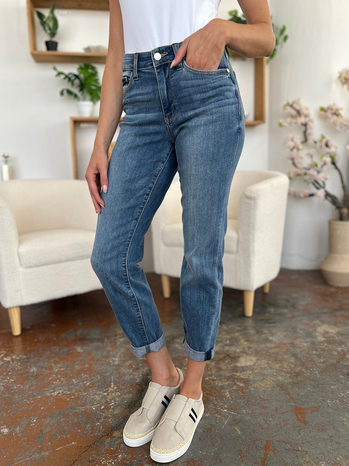 Trendsi plus size cuffed hem jeans in medium wash worn with white slip-on shoes indoors