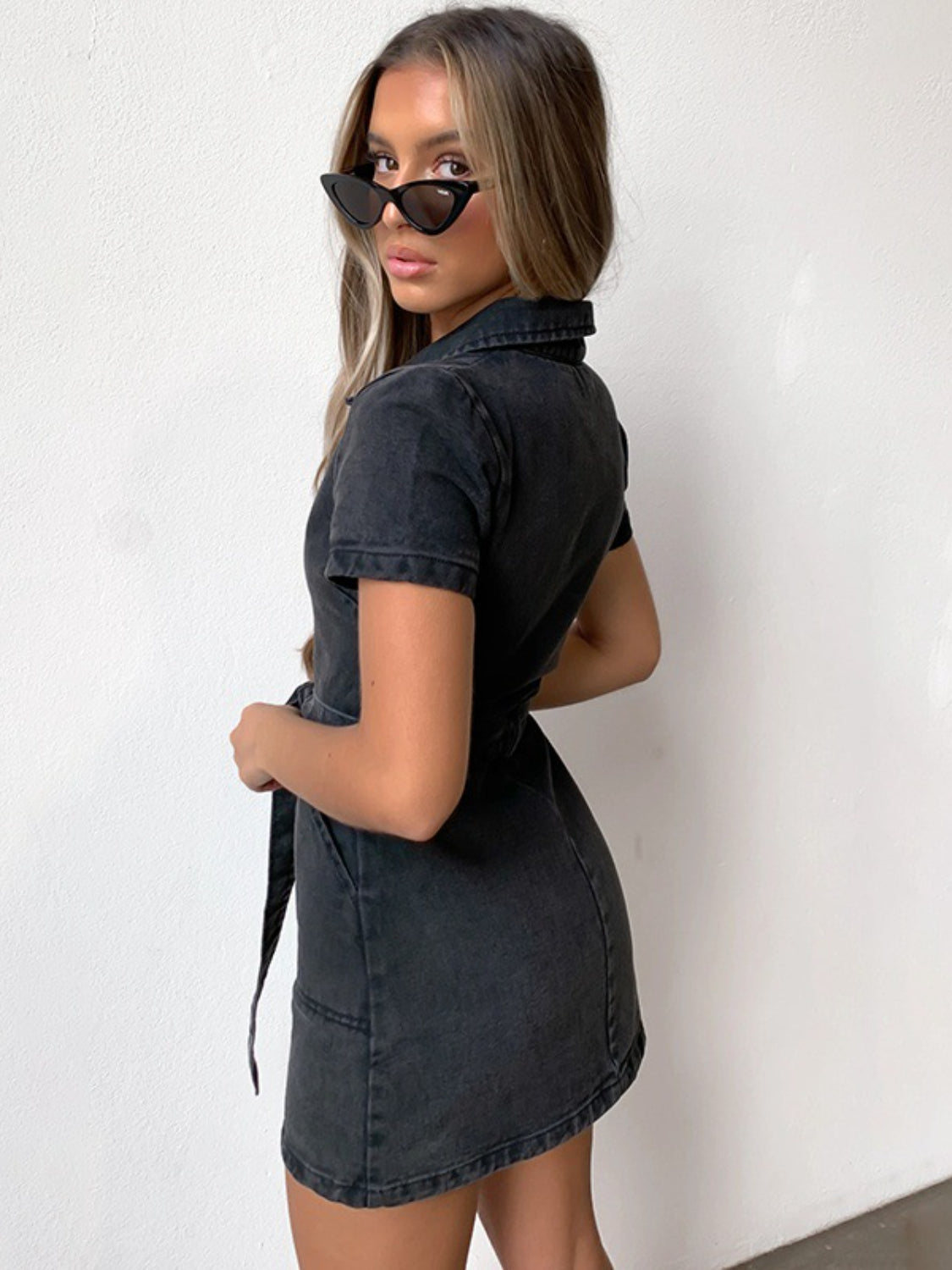 Trendsi plus size denim dress in black with short sleeves and collar worn by woman with sunglasses
