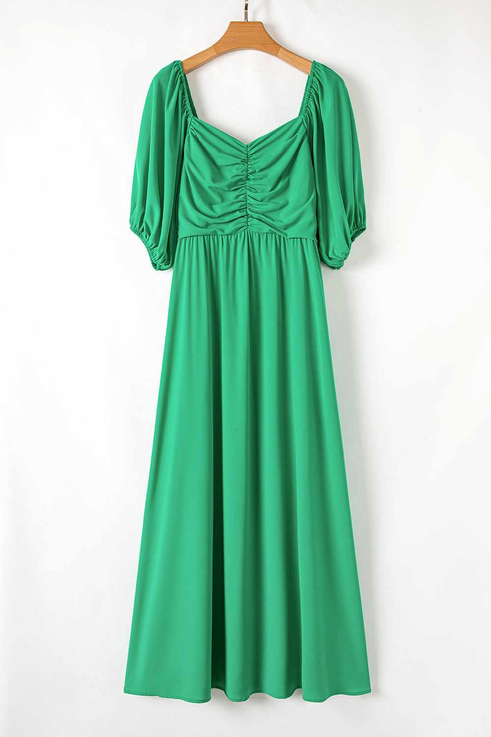 Plus size green puff sleeve dress with ruched bodice and flowing maxi skirt
