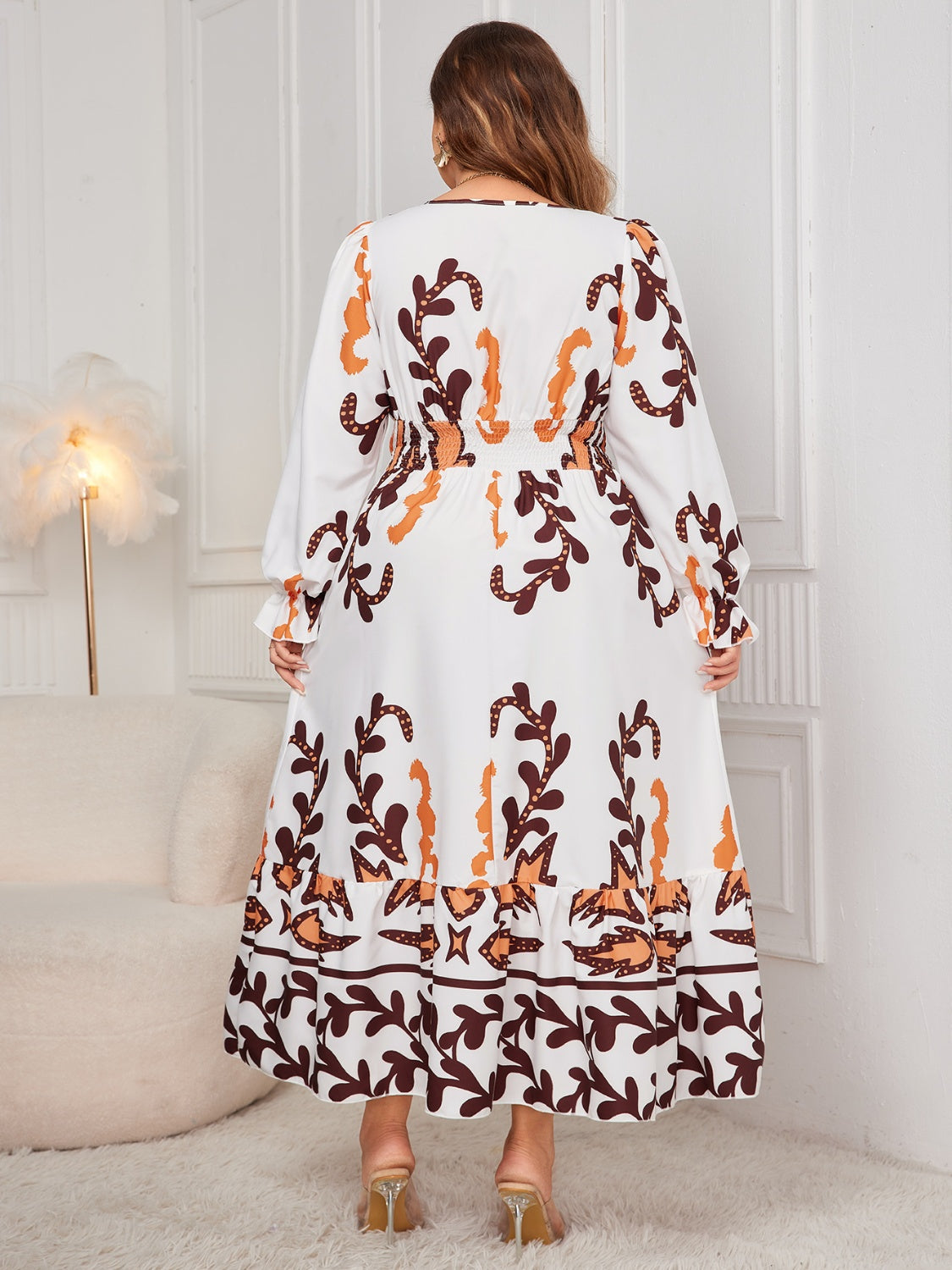 Back view of plus size honey print dress for women with long sleeves and flowy skirt by Trendsi