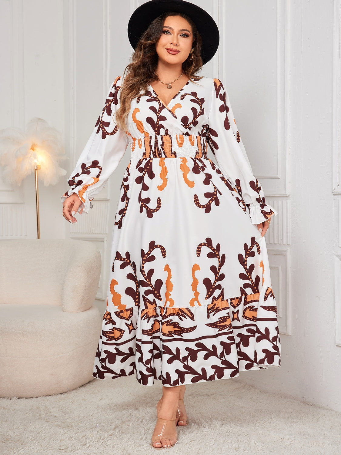 Plus size honey print dress for women with long sleeves and a flowy skirt worn with a black hat
