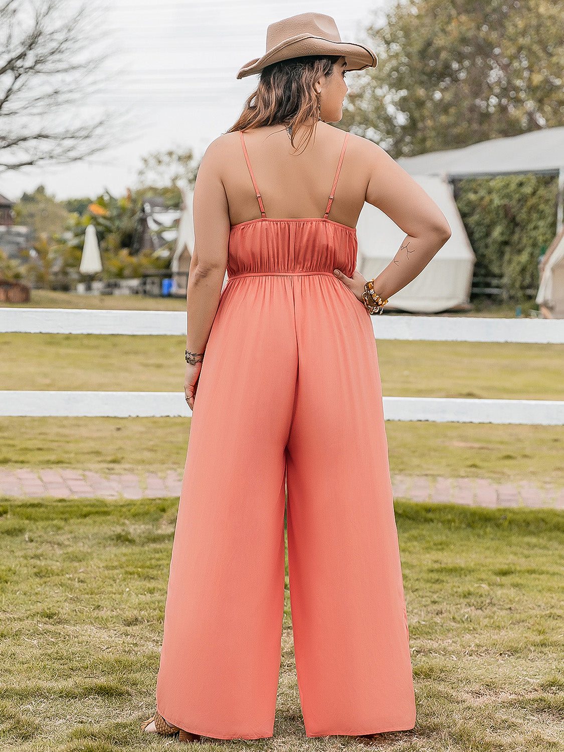 Trendsi plus size lace jumpsuit in coral with thin straps and wide-leg pants shown from back