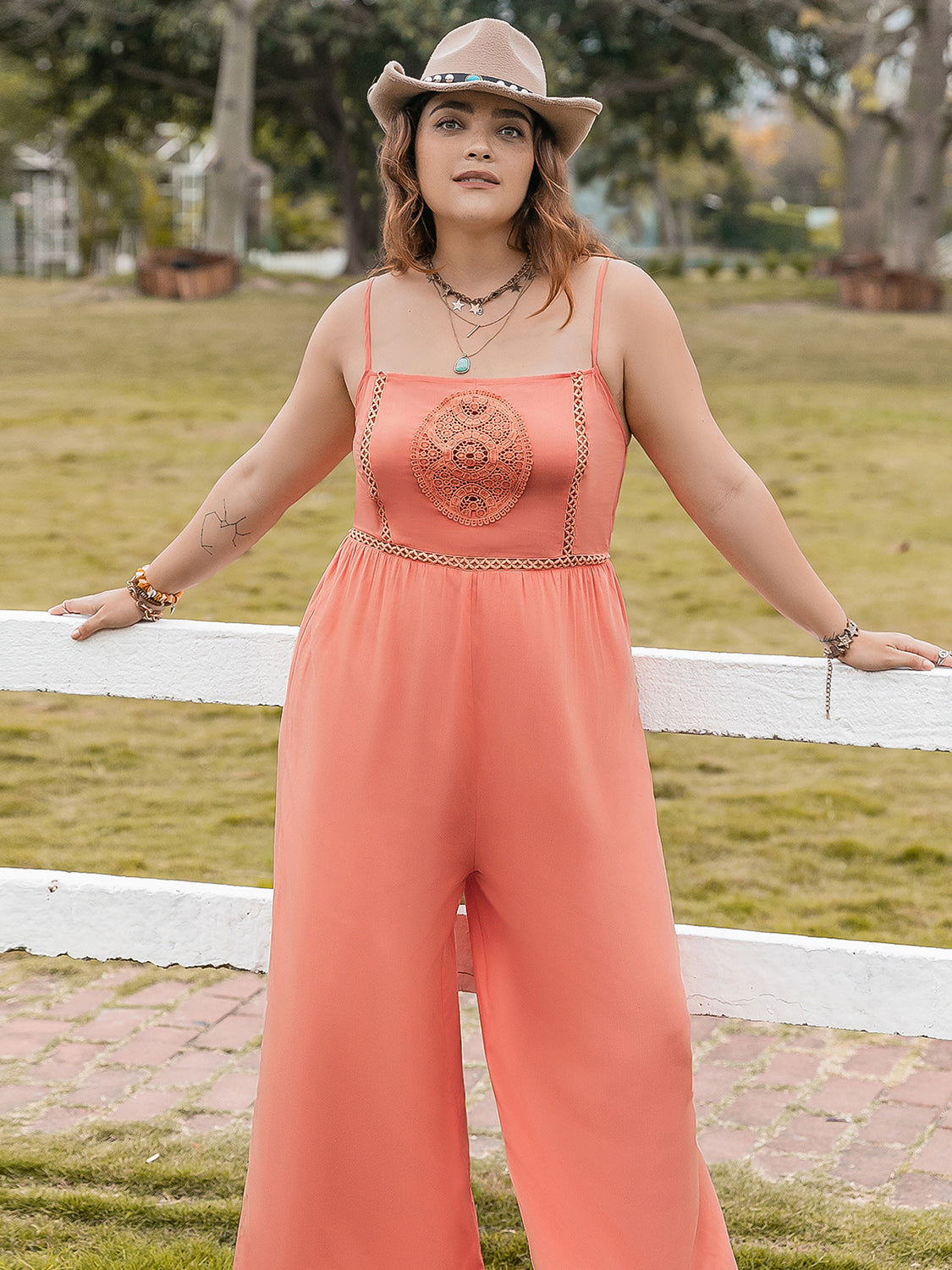 Plus size lace jumpsuit in coral with spaghetti straps and intricate lace detailing by Trendsi