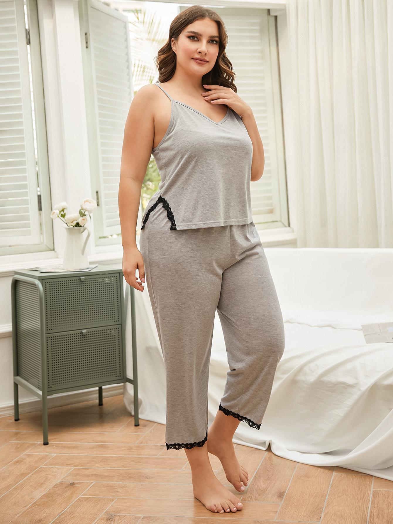 Plus size lace trim pajama set in gray with black lace details worn by a woman at home