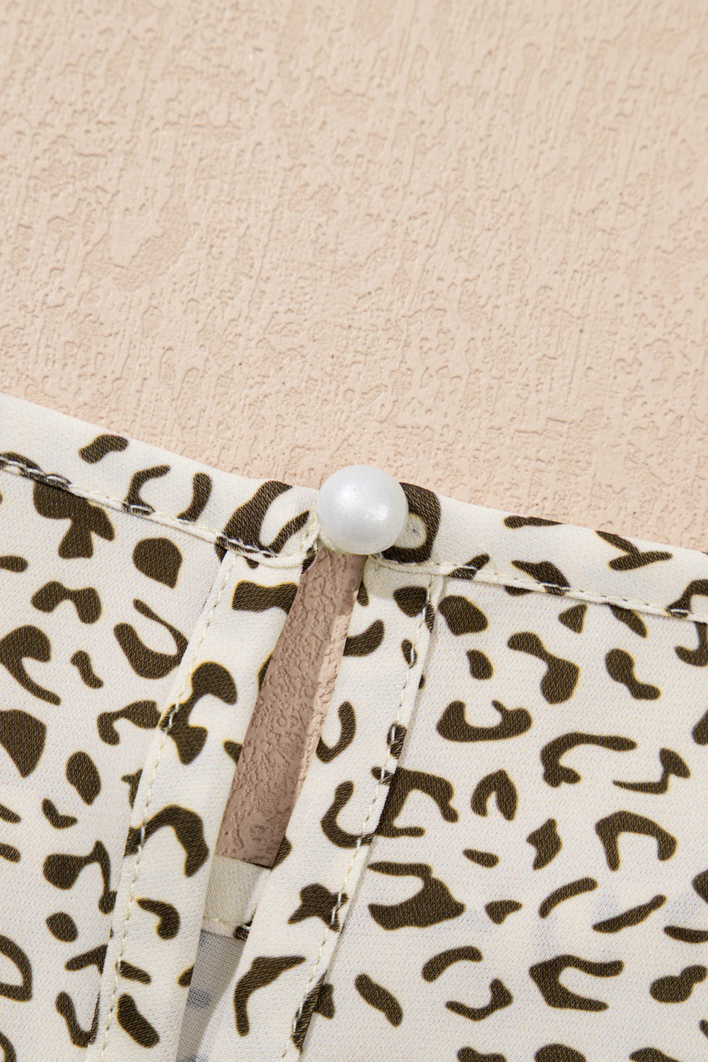 Close-up of plus size leopard print dress with pearl button detail on kjplussizefashion