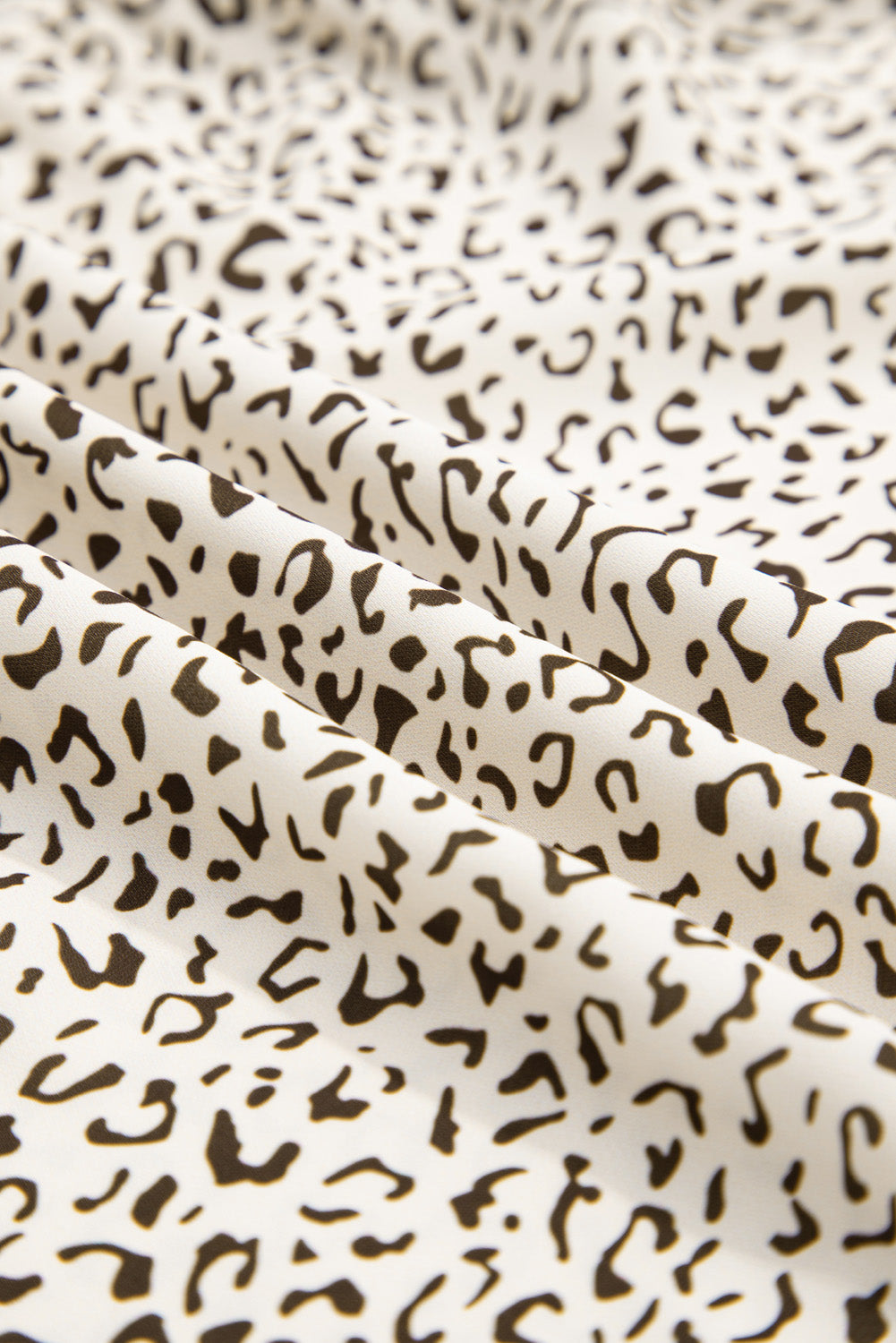 Close-up of soft fabric with black and white pattern for plus size leopard print dress