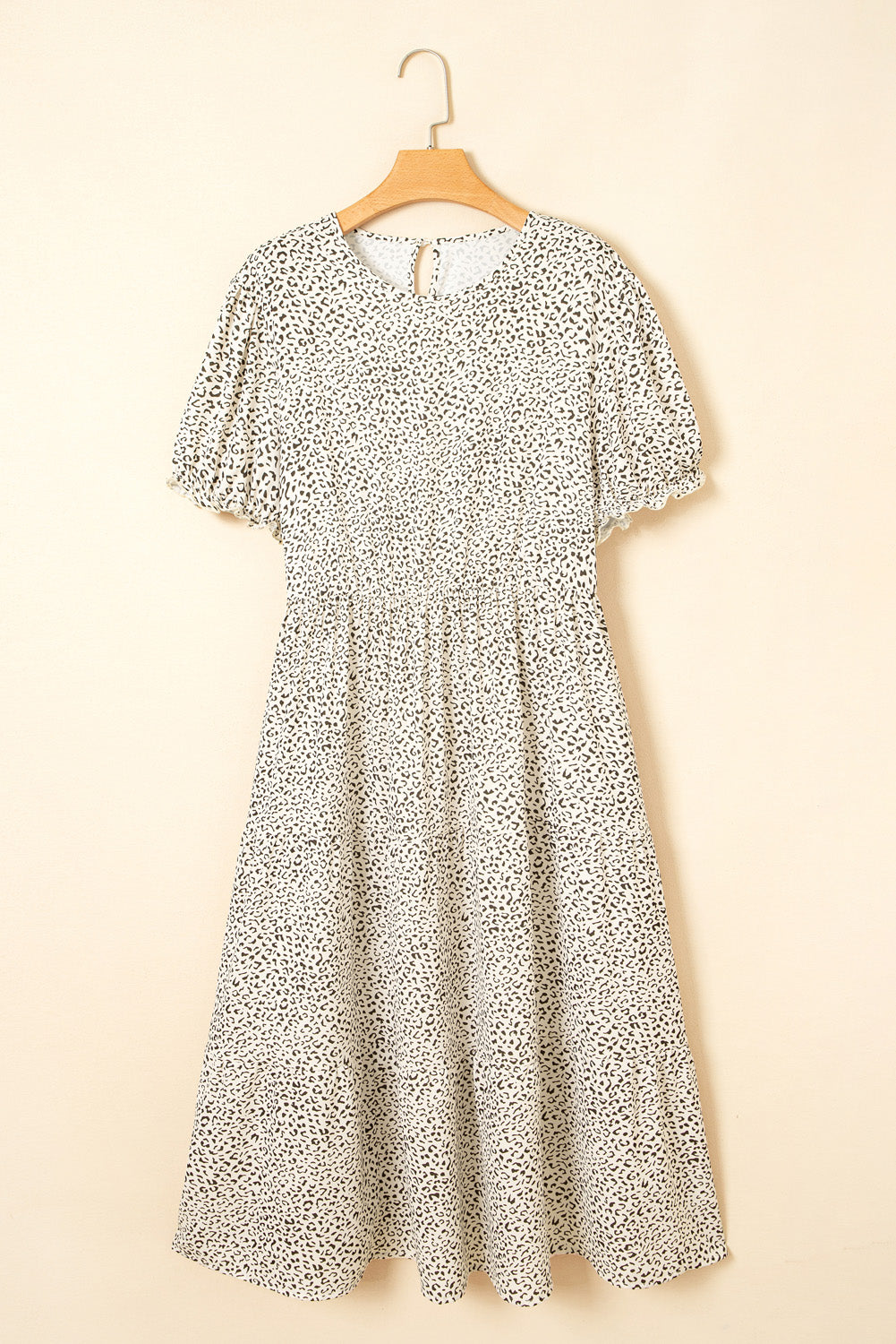 kjplussizefashion plus size leopard print dress midi length with short puff sleeves on a hanger