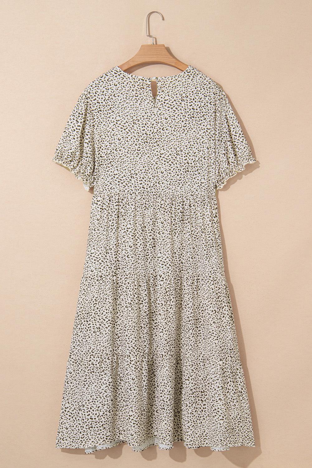 Beige plus size leopard print frill trim short sleeve flared dress hanging on wooden hanger against beige background