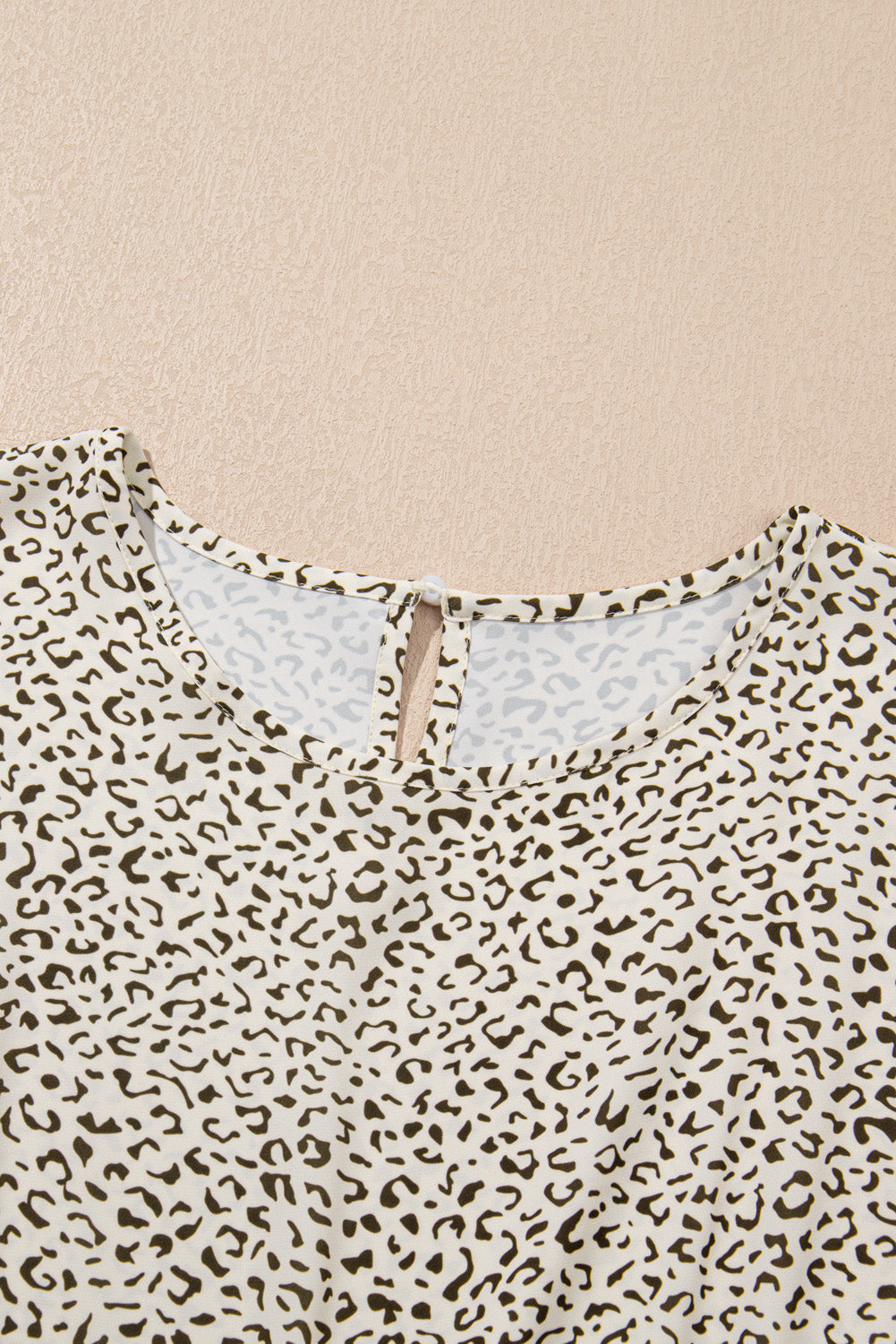 Close-up of plus size leopard print dress neckline and button closure by kjplussizefashion