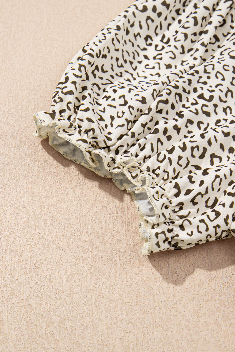Close-up of kjplussizefashion plus size leopard print dress sleeve with elastic cuff detail