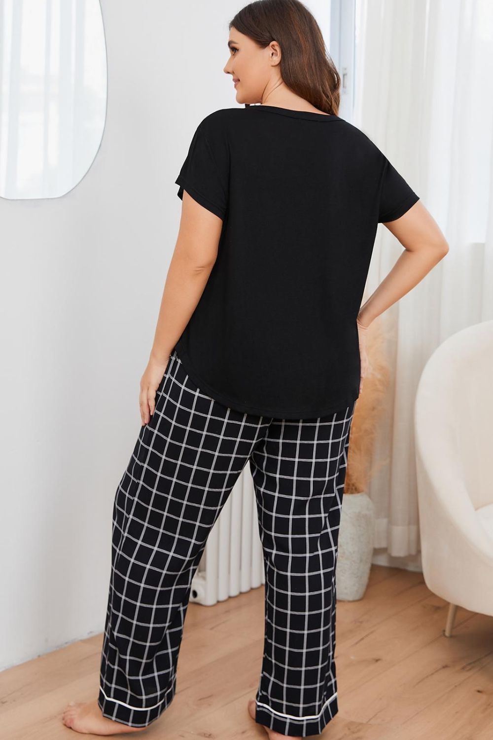 plus size loungewear set featuring black top and black and white checkered pants