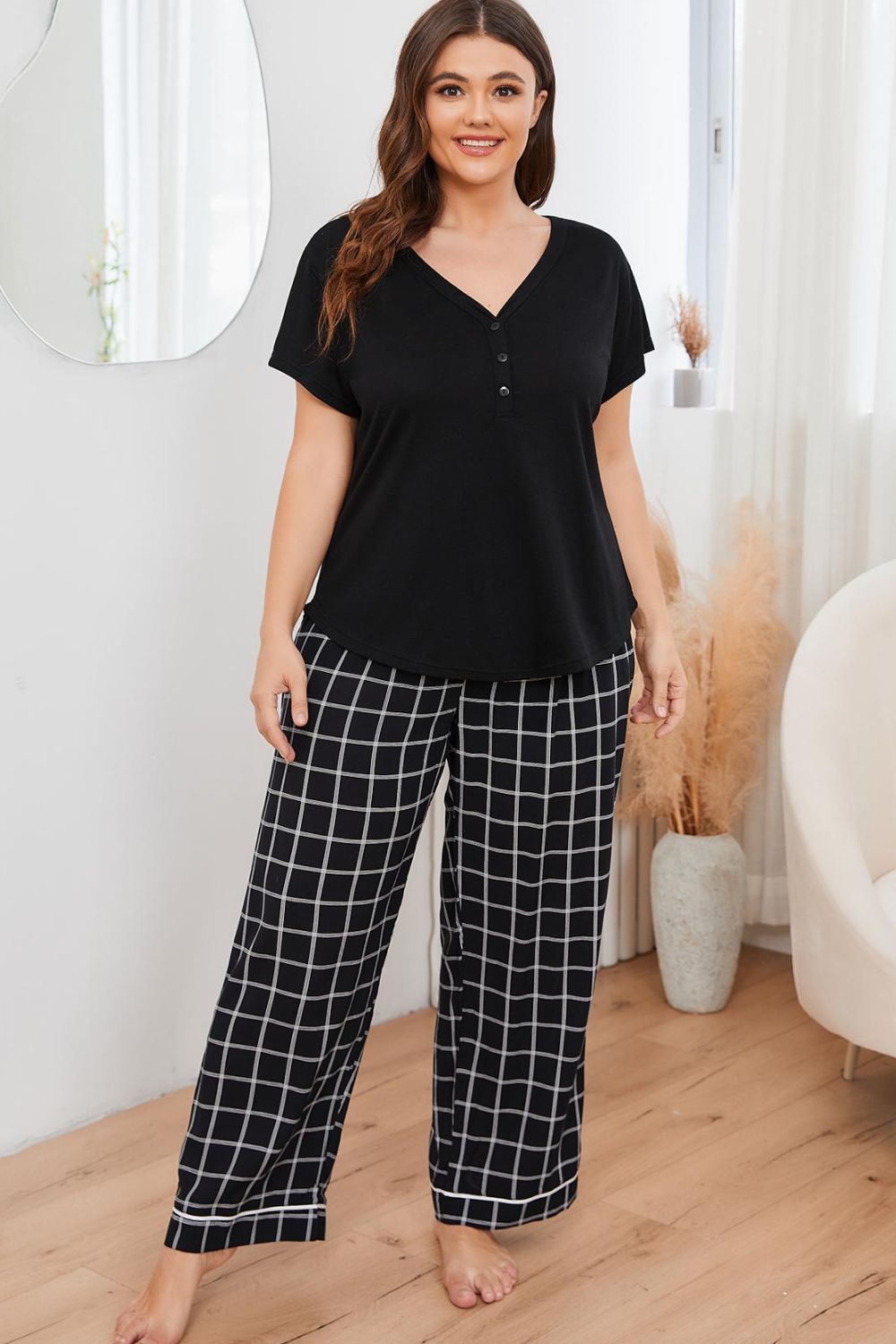 plus size loungewear set with black short sleeve top and checkered wide-leg pants