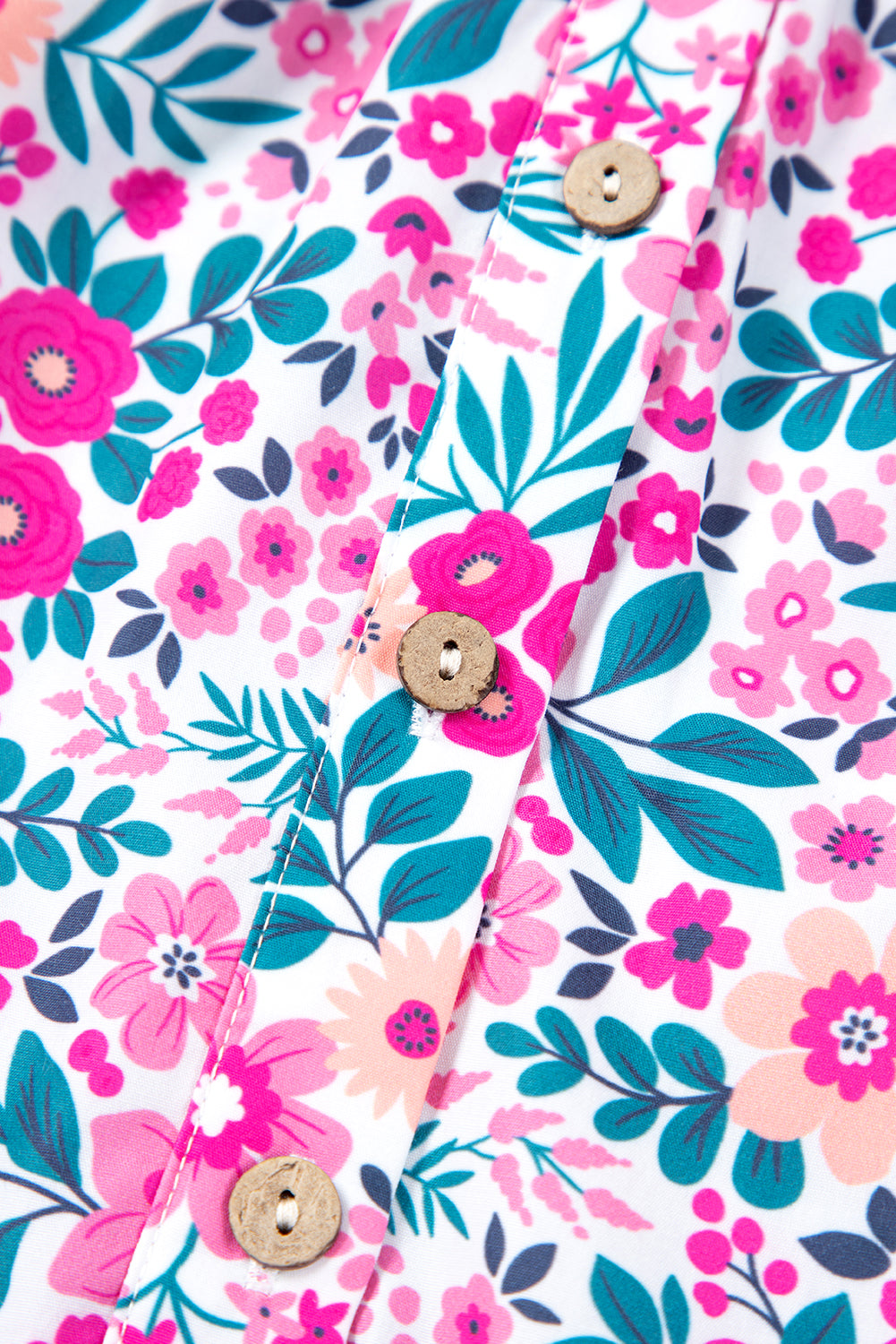 Close-up of pink plus size floral dress fabric with half button detail and vibrant flowers