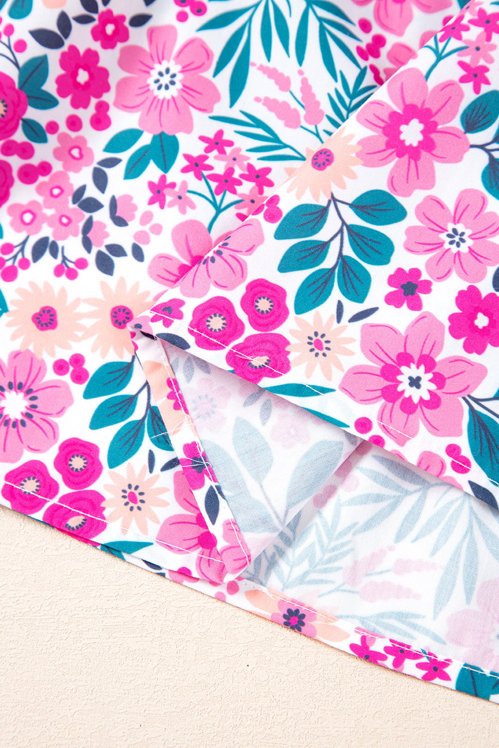 Close-up of pink floral pattern fabric for plus size A-line mini dress with puff sleeves and half button design