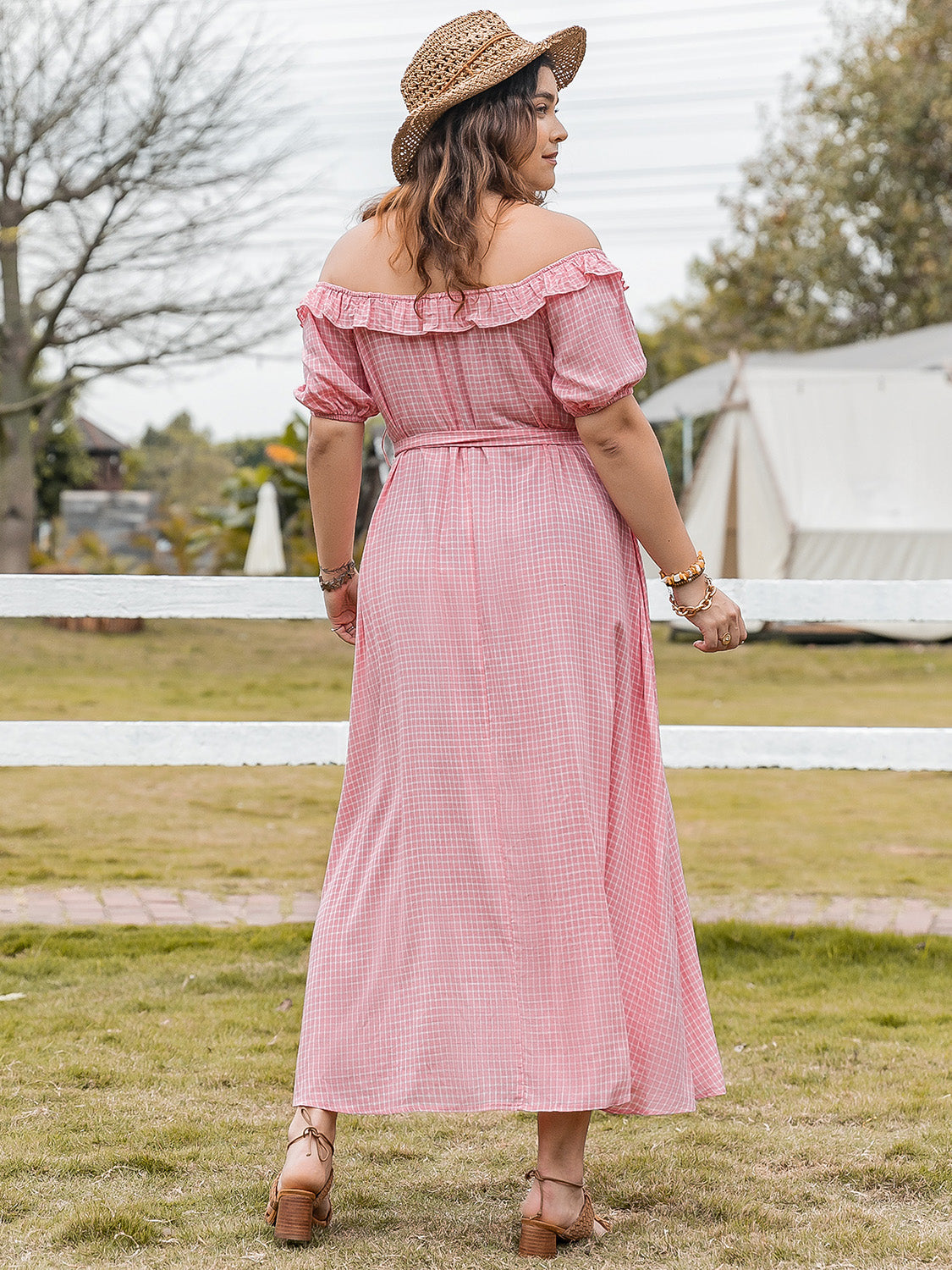 Plus size plaid off-shoulder short sleeve midi dress with adjustable waist tie and ruffled neckline worn outdoors