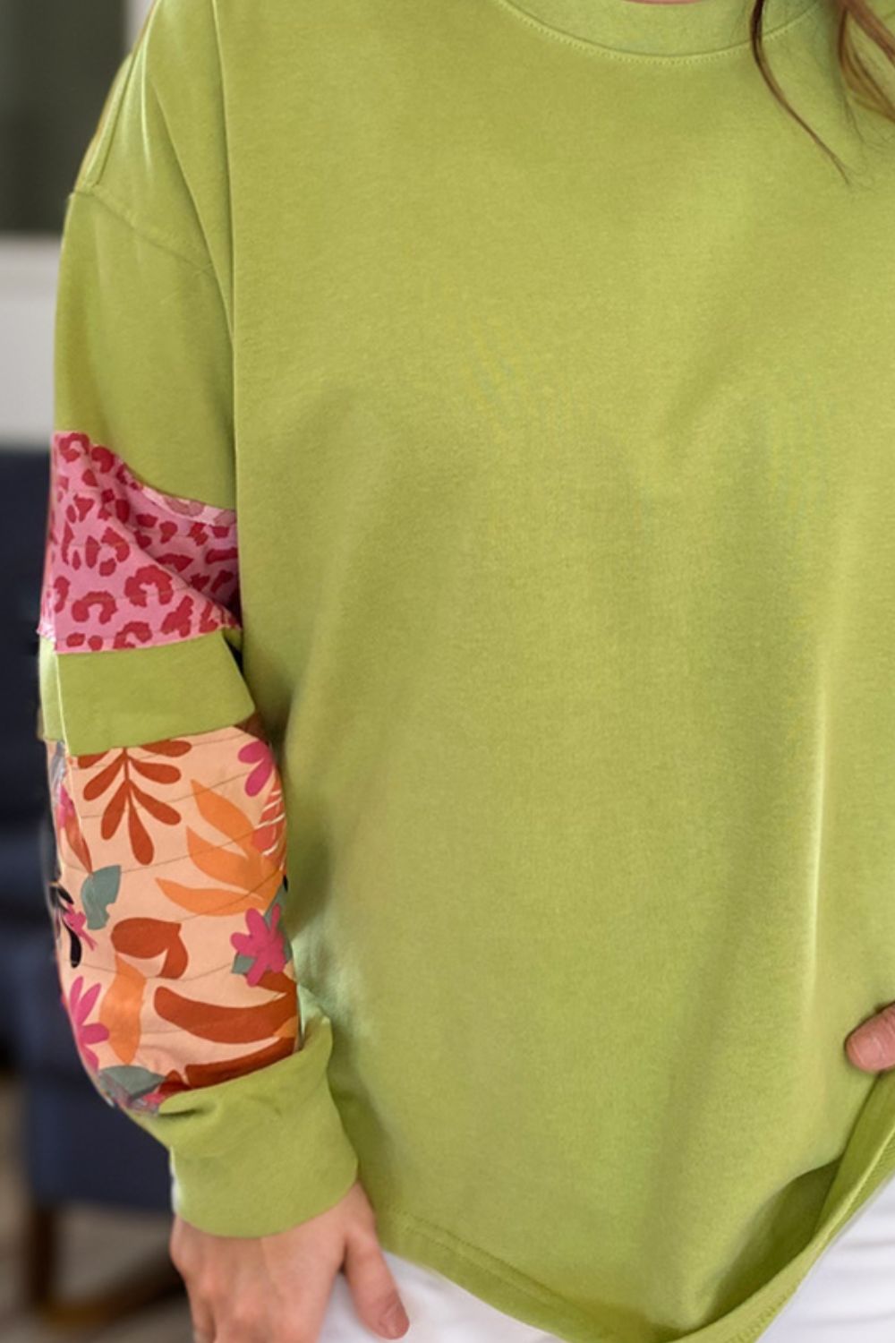Plus size sweatshirt with colorful printed animal and floral pattern sleeves and relaxed round neck design
