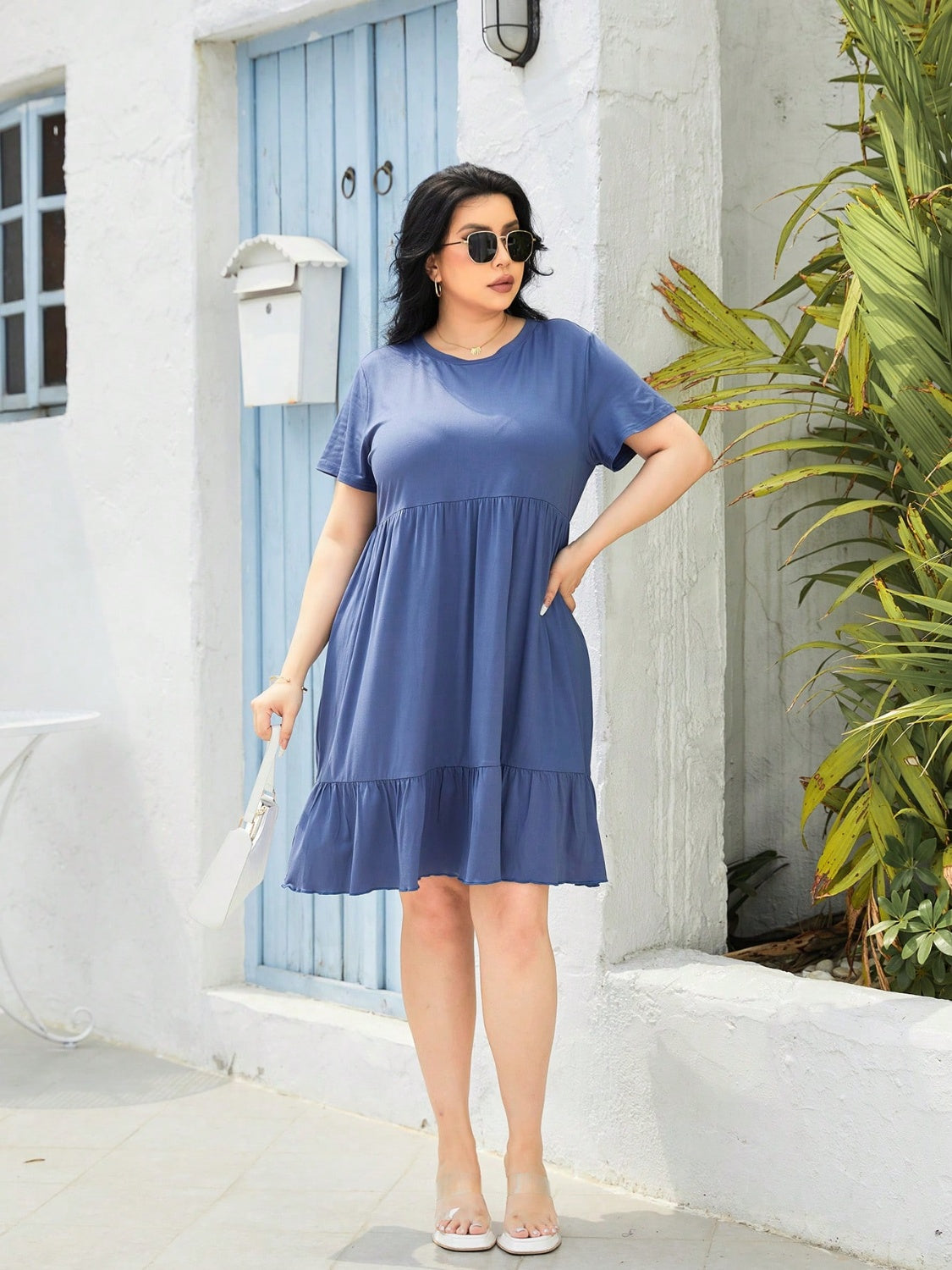 Trendsi plus size round neck dress in blue with short sleeves and ruffle hem worn outdoors
