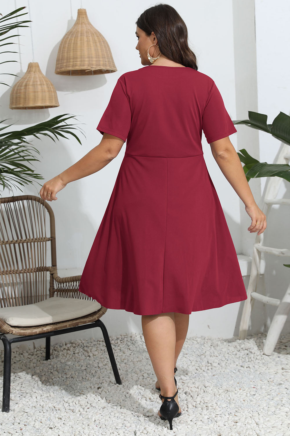 Trendsi plus size round neck openwork dress in red shown from back with short sleeves and flared skirt
