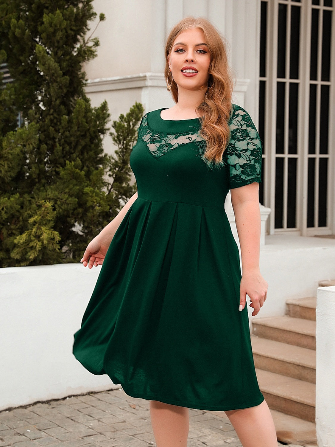 Plus size ruched dress in dark green with lace sleeves and neckline by Trendsi